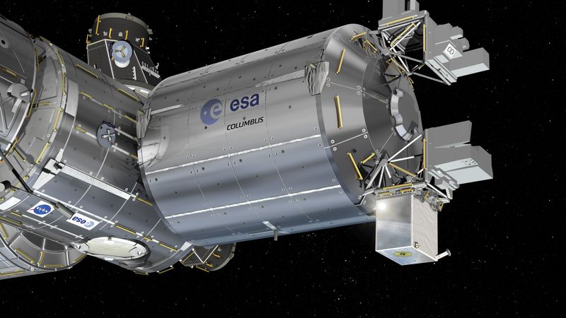 the module is cylindrical in shape attached to other cylindrical module. At the end of it there are multiple cuboid attachments, the clock being one of them.