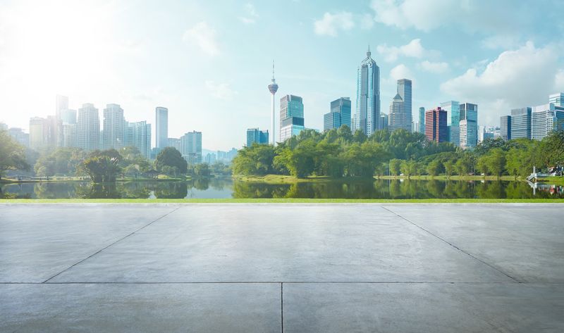 Empty cement floor with lake garden and modern city skyline in backgroun