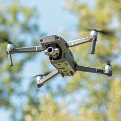 sketch of "aerial screw" by Leonardo da Vinci on the left, and photo of a modern drone flying on the right.