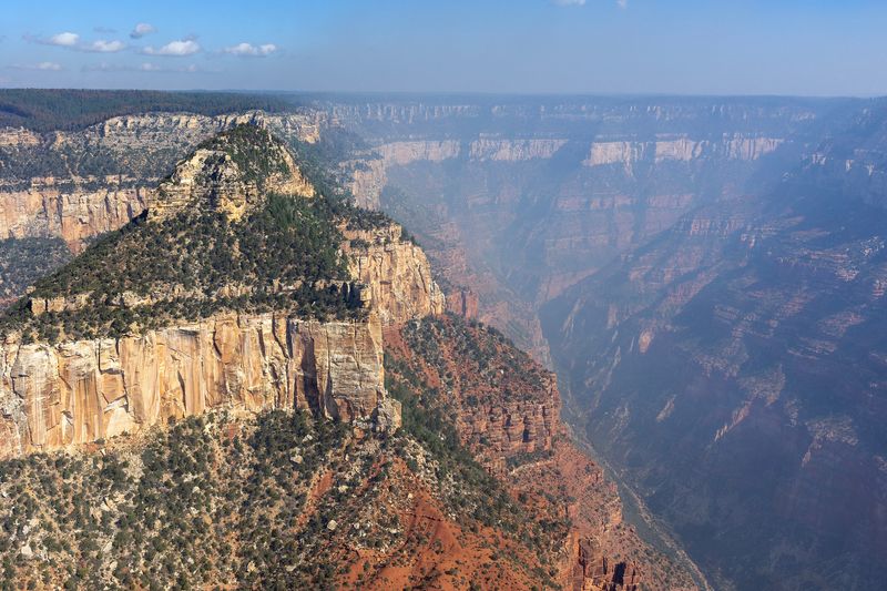 Smoke from the Dragon Bravo Fire in the Grand Canyon National Park around Oaz Butte and Widforss Point on the left, plus Transept Canyon on the right.