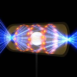 A digital model showing the hohlraum - shaped like a faded yellow cylinder - being bombarded by lasers from either end. The faded cylinder contains a white orb at the center which is surrounded by smaller yellow/orange circles indicating where the laser beams are touching the interior and bouncing towards the orb.