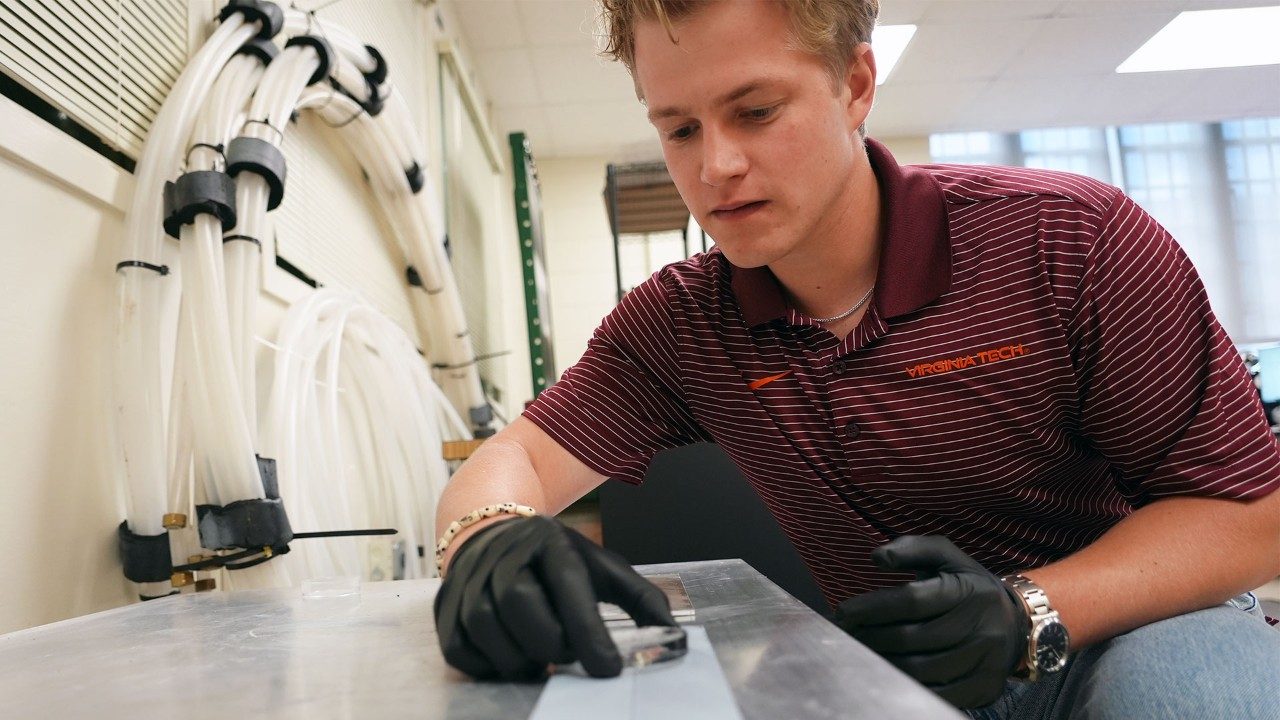 Jack Tapocik with one of the ice disks he made self-propel using just its own meltwater and the groves in the sheet it sits on.