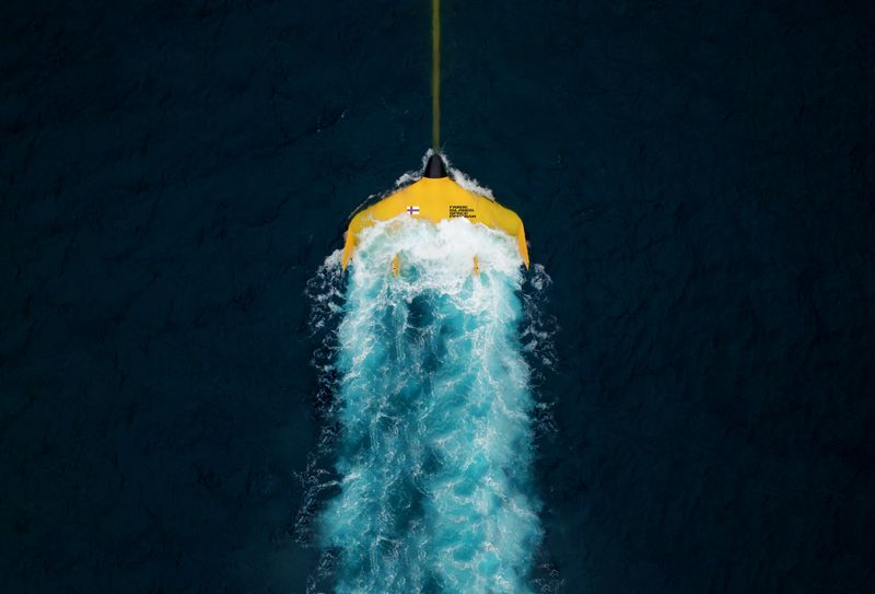 the bright yellow tidal kite luna 12 with the words Faroe Islands Space Program, on the surface of the dark blue atlantic.