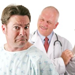 White male nervous-looking patient about to be examined by a smiling white male doctor who is putting a white medical glove. Isolated on white.