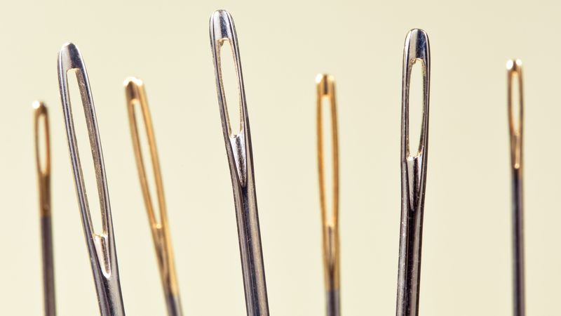 close-up of series of needles' eyes