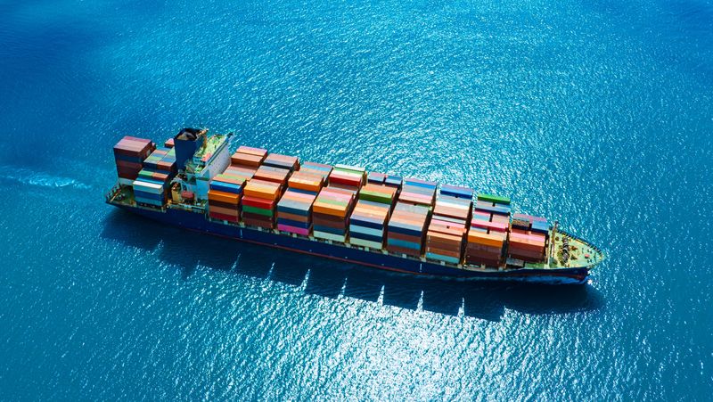 aerial view of a freighter ship loaded with cargo containers