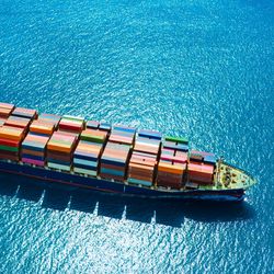 aerial view of a freighter ship loaded with cargo containers