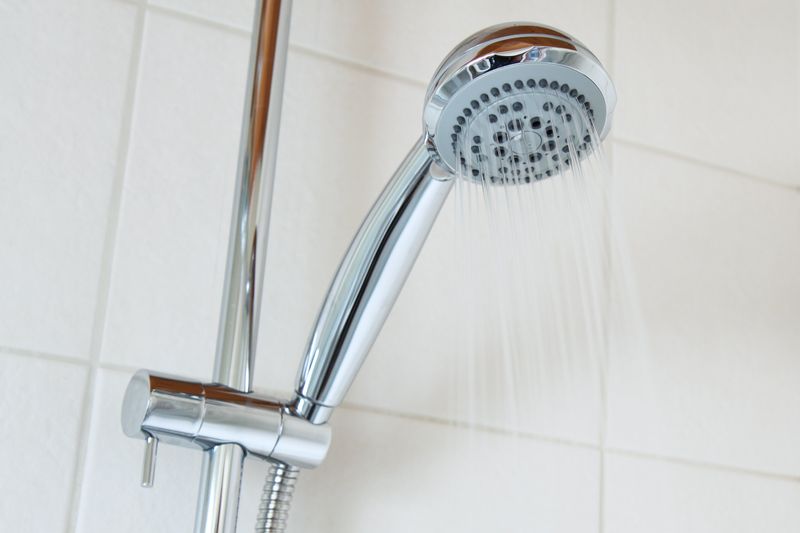 silver showerhead with running water