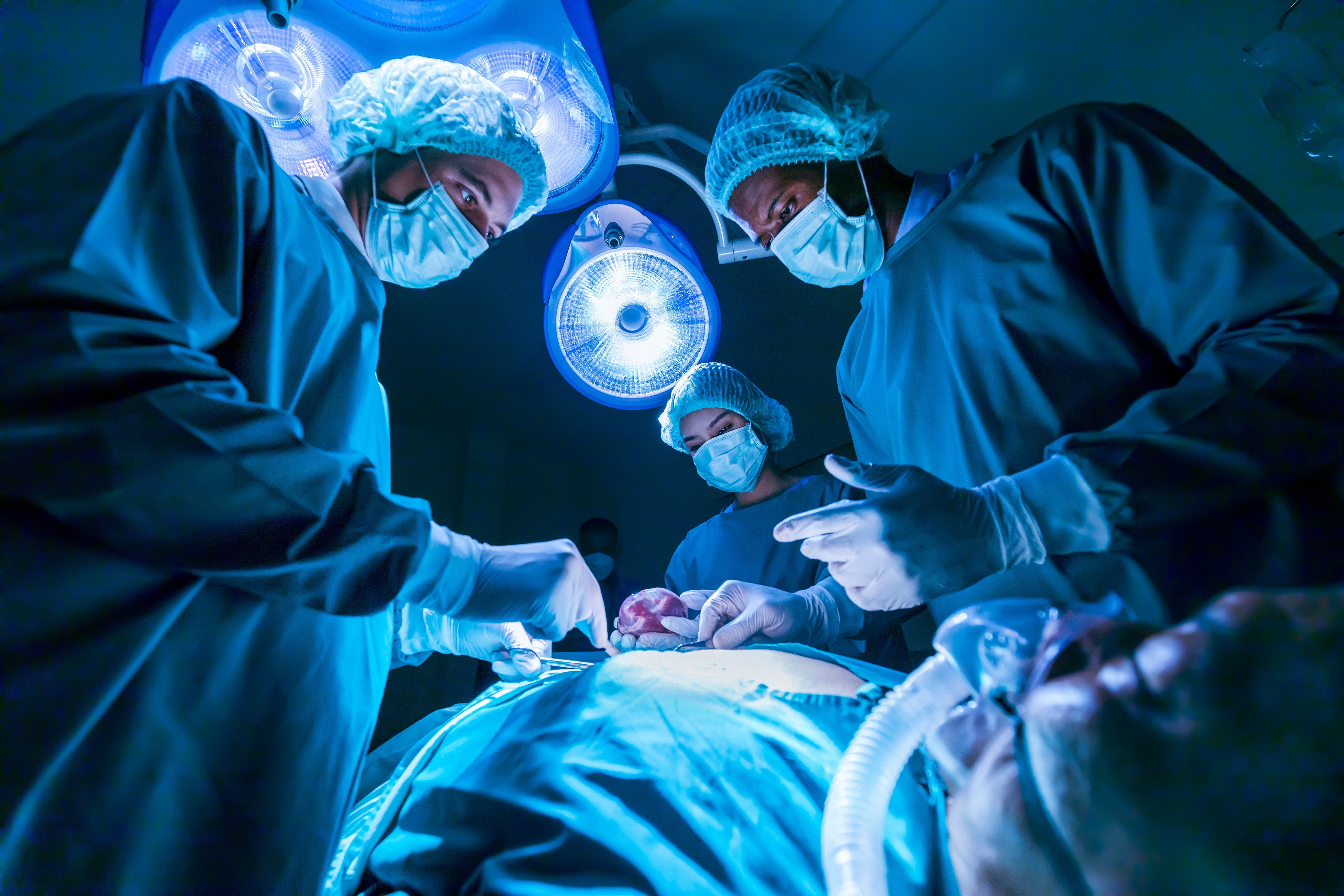 Surgeons operating on patient