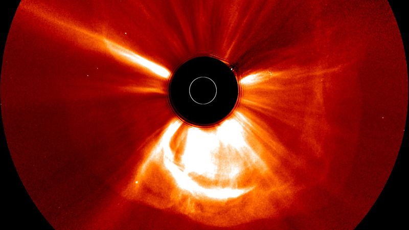 The image shows the sun blocked by a dark circuled and lage wave of plasma expanding around it