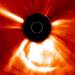 The image shows the sun blocked by a dark circuled and lage wave of plasma expanding around it