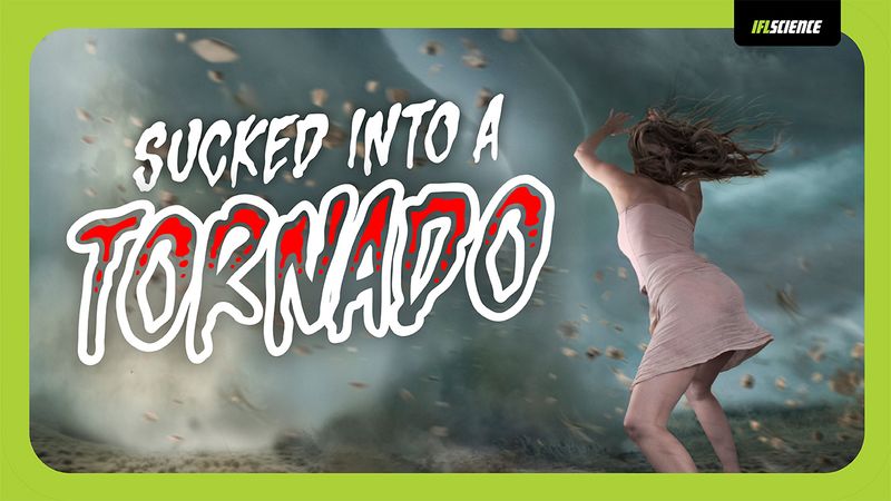a woman backs away from a tornado