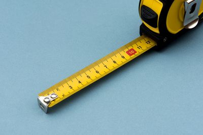 Tape measure on blue background