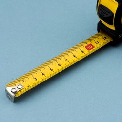 Tape measure on blue background