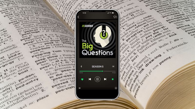 A phone showing season 5 of The Big Questions, on background of a close up photograph of an open dictionary
