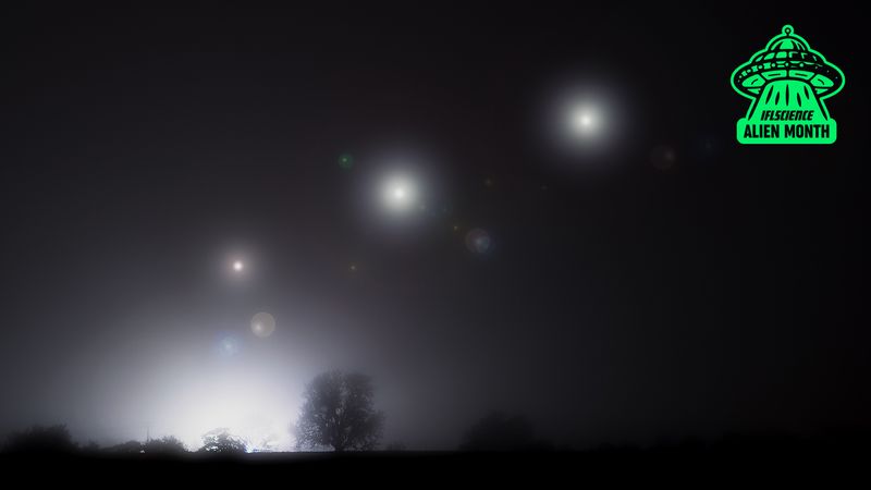 Three glowing orbs in the night sky