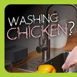 A person washes chicken in the sink