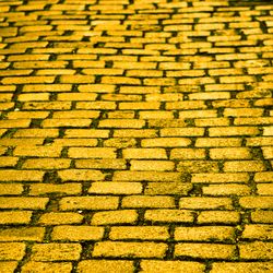 A yellow brick road in a street.