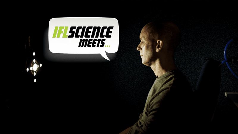 Anil Seth sitting in front of a strobe light.