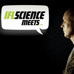 Anil Seth sitting in front of a strobe light.