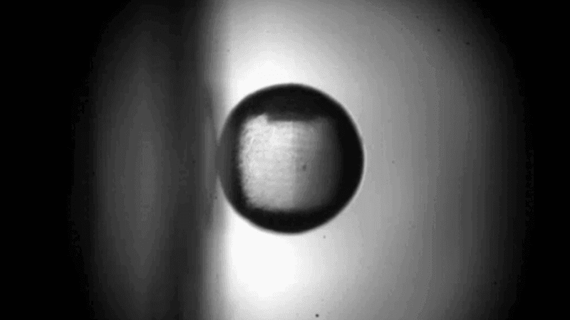 A ball rolling vertically down a surface.