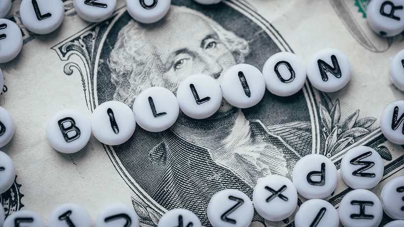 The word "billion" placed on top of a bank note.