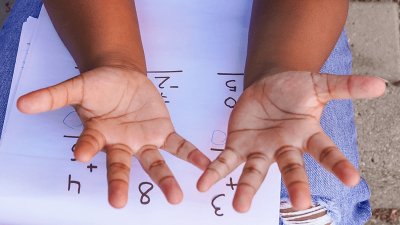 Girl counting on her fingers.