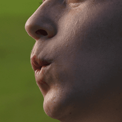 A woman pursing her lips and blowing air.