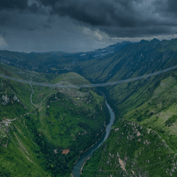 The Huajiang Grand Canyon Bridge (pictured here under construction) is part of an expressway in Zhenfeng County in the southwest of Guizhou province, China. 