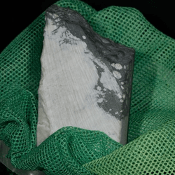 a slab of a white/gray mineral wrapped in a green gauze