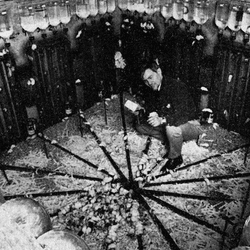 John Calhoun inside a large mouse enclosure with water bottles surrounding it.