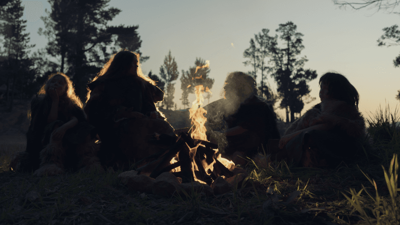 neanderthals gathered around a fire
