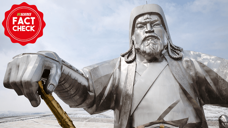 silver Genghis khan in statue holding a gold staff