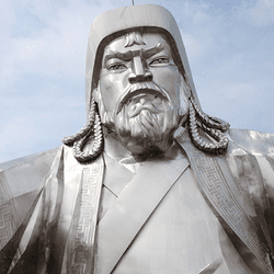 silver Genghis khan in statue holding a gold staff